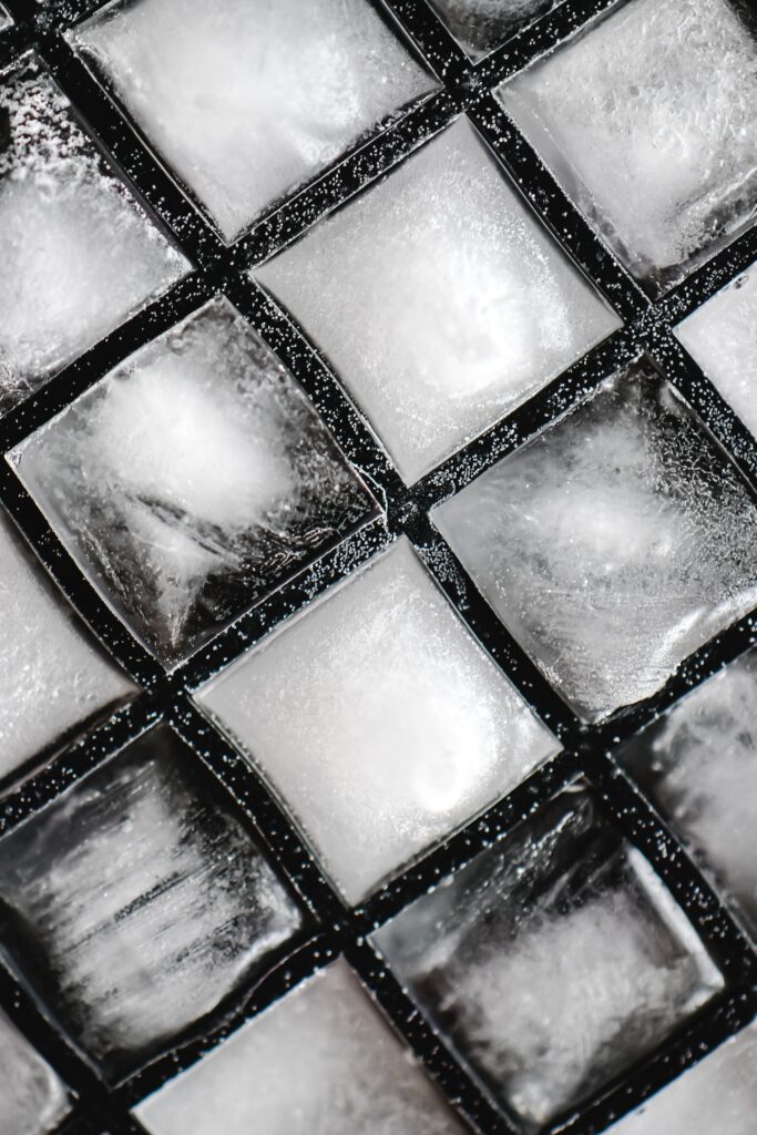 Close-up of frozen ice cubes in a geometric grid pattern creating an abstract art effect.